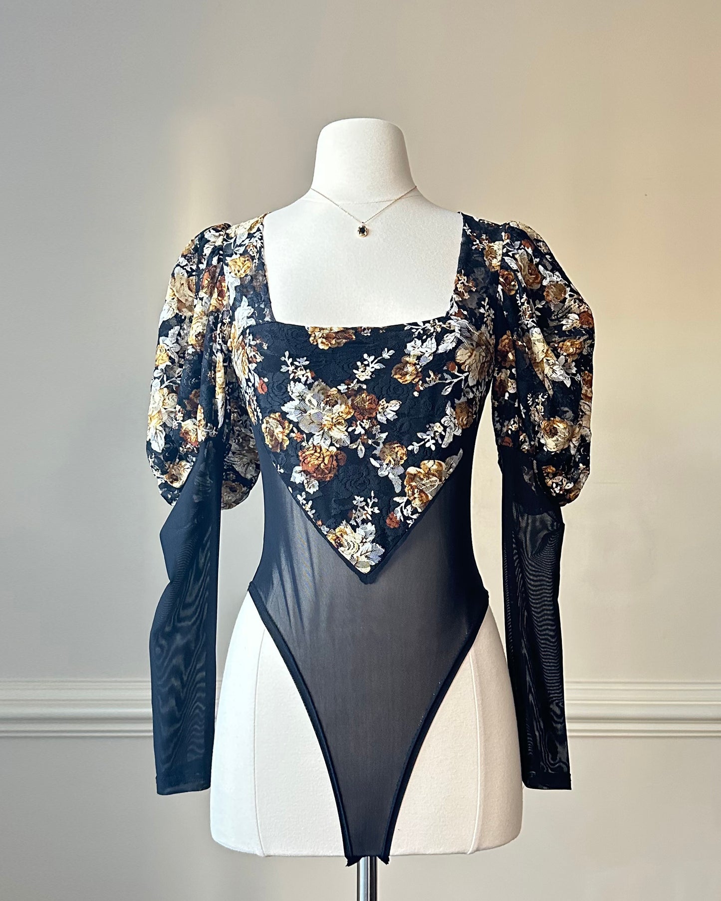 Unique Bodysuit featuring Sheer Black Fabric and Floral Patterned Sleeves