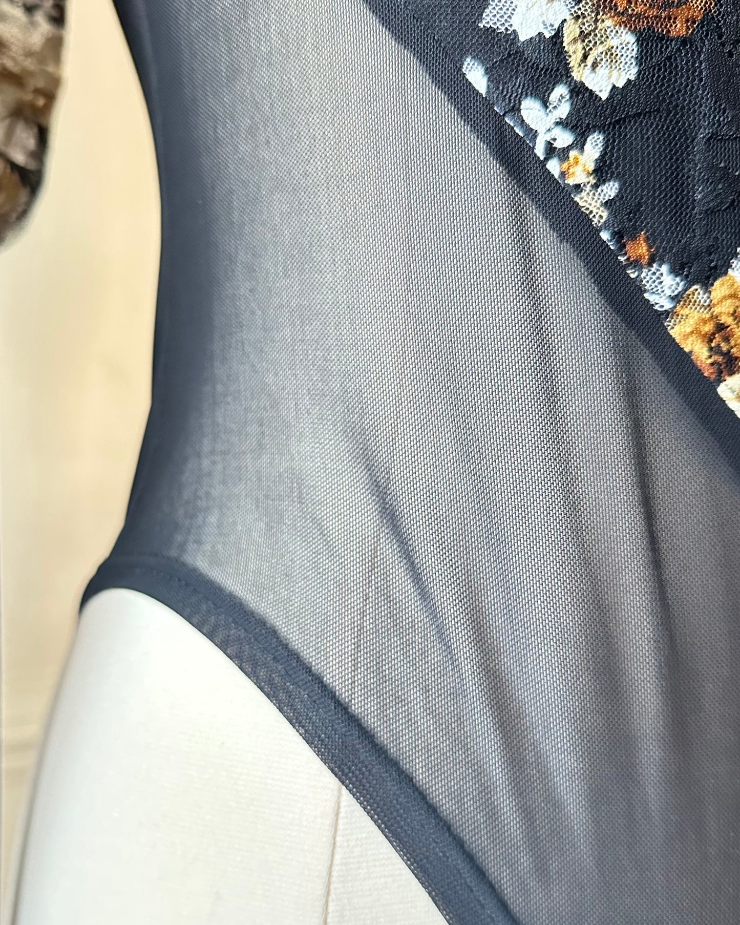 Unique Bodysuit featuring Sheer Black Fabric and Floral Patterned Sleeves