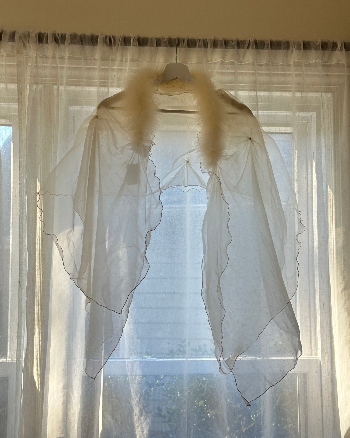 Ethereal fairy sheer poncho featuring reflecting specks on sheer mesh fabric