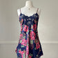 Dark navy satin dress featuring overlapping paisley and flower pattern