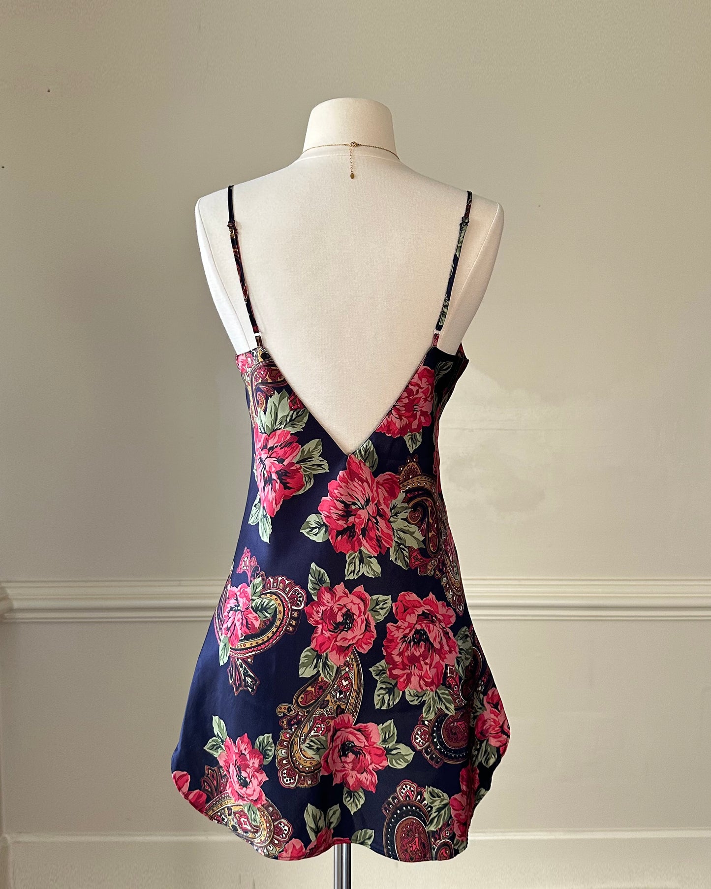 Dark navy satin dress featuring overlapping paisley and flower pattern