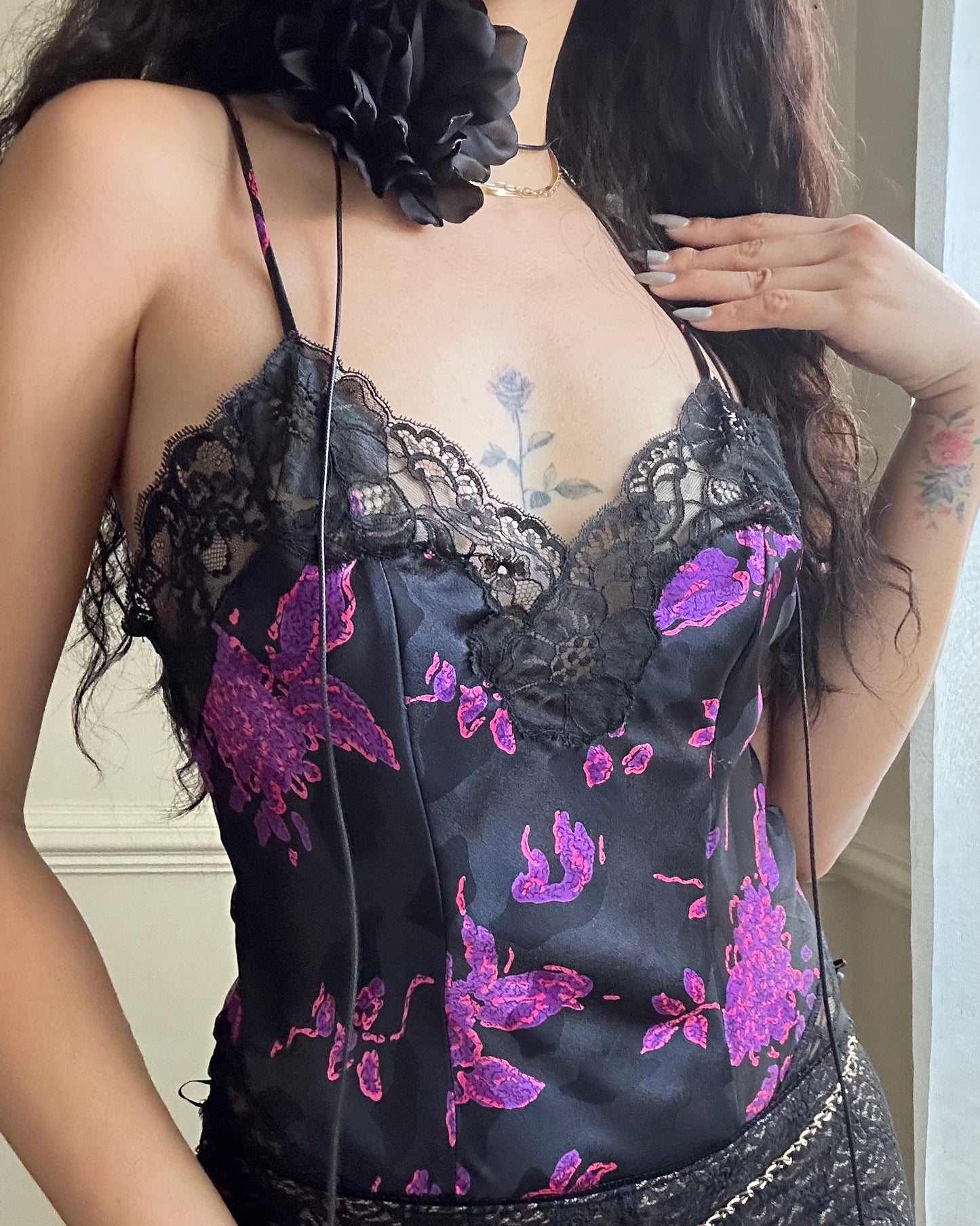 Vintage DIOR’s satin black bodysuit featuring vibrant purple floral prints