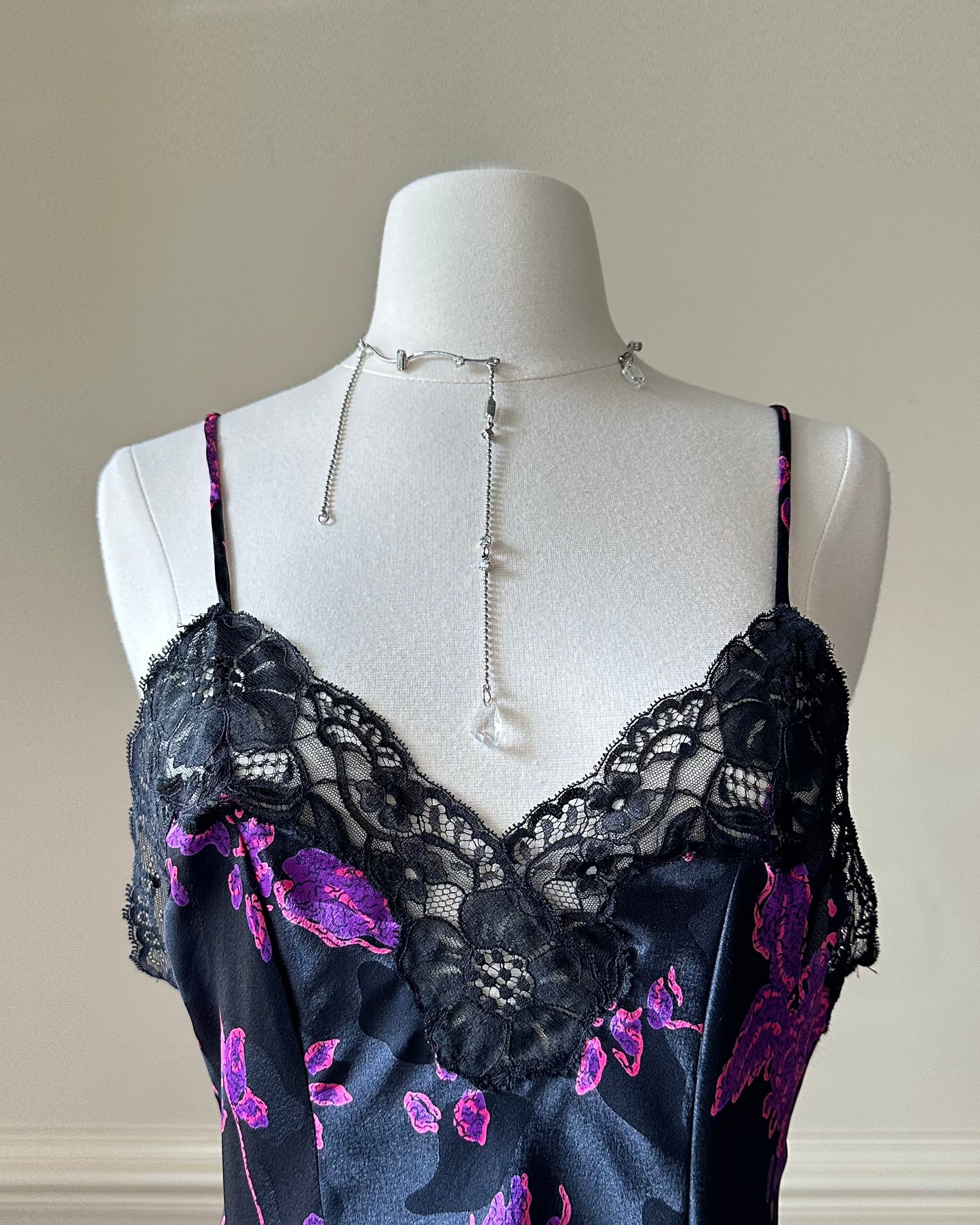 Vintage DIOR’s satin black bodysuit featuring vibrant purple floral prints