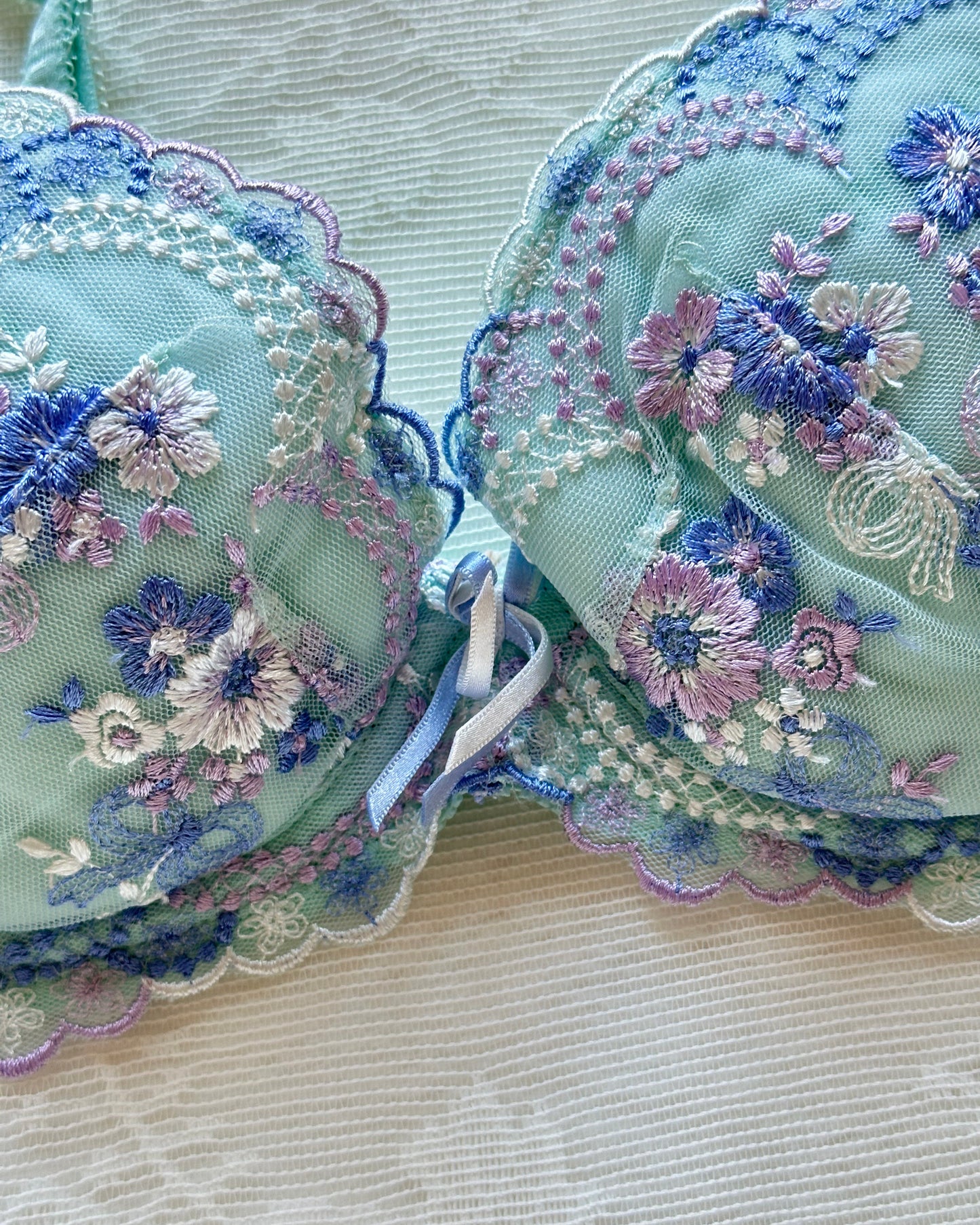 Turquoise blue Japanese brassiere featuring blue and lavender petite flowers embroidery