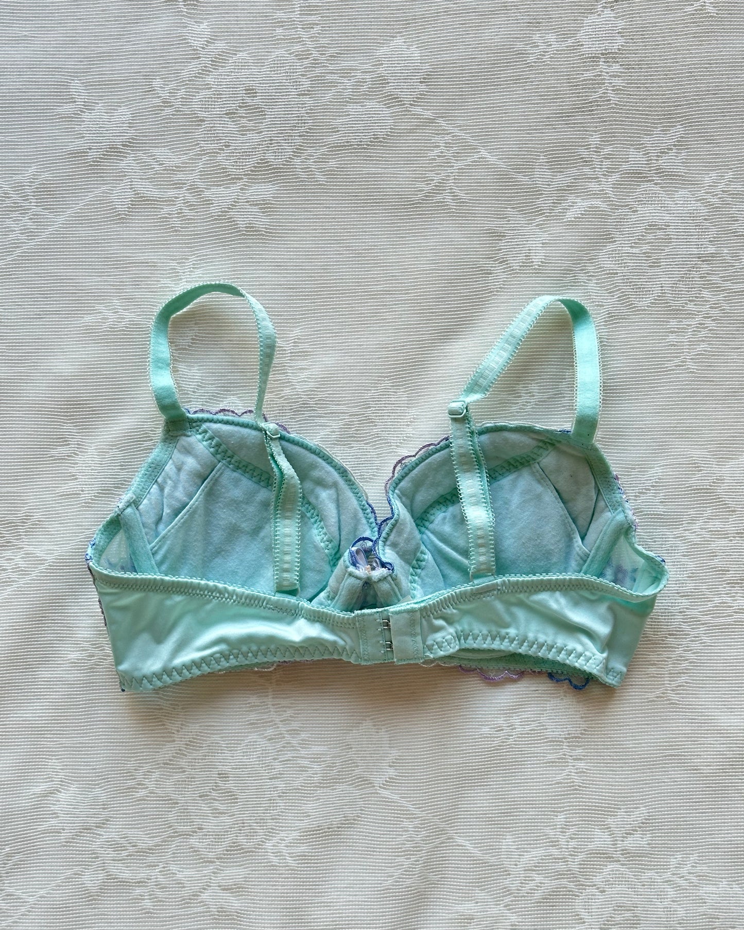 Turquoise blue Japanese brassiere featuring blue and lavender petite flowers embroidery