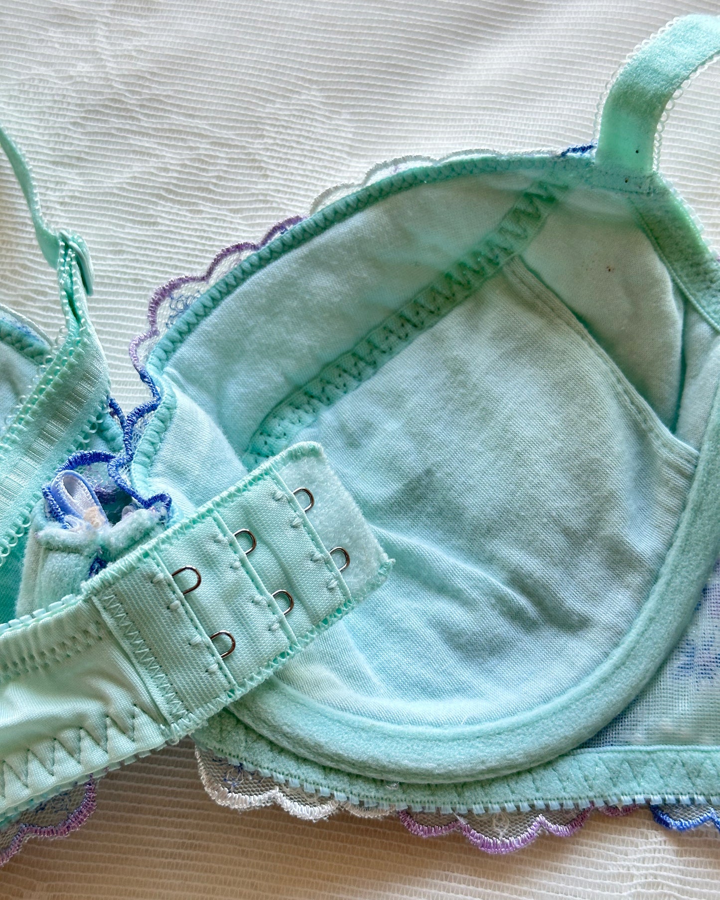 Turquoise blue Japanese brassiere featuring blue and lavender petite flowers embroidery