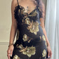 Sultry sheer black slip dress featuring golden blooming flowers print