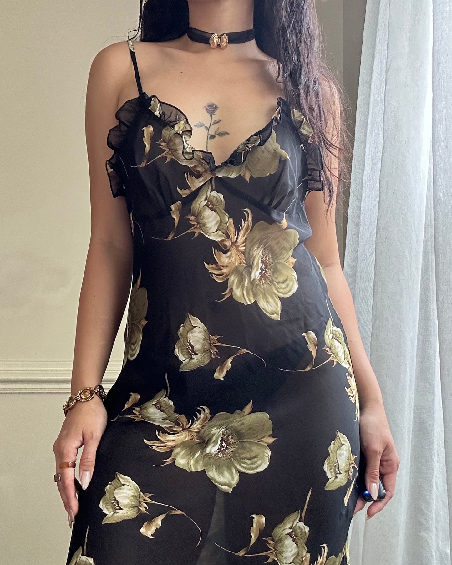 Sultry sheer black slip dress featuring golden blooming flowers print