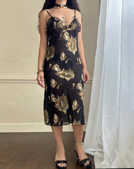 Sultry sheer black slip dress featuring golden blooming flowers print