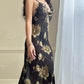 Sultry sheer black slip dress featuring golden blooming flowers print