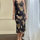 Sultry sheer black slip dress featuring golden blooming flowers print