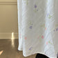 Vintage white maxi nightgown with pastel floral print and subtle satin stripe texture
