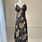 Sultry sheer black slip dress featuring golden blooming flowers print