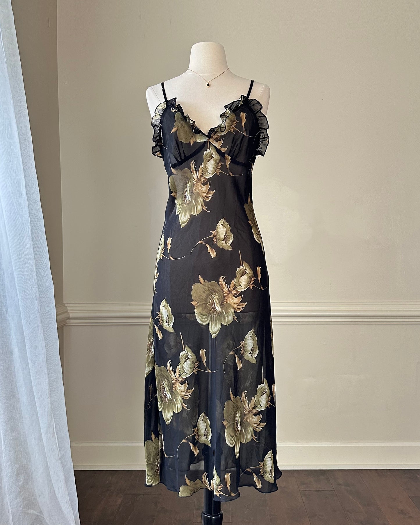 Sultry sheer black slip dress featuring golden blooming flowers print