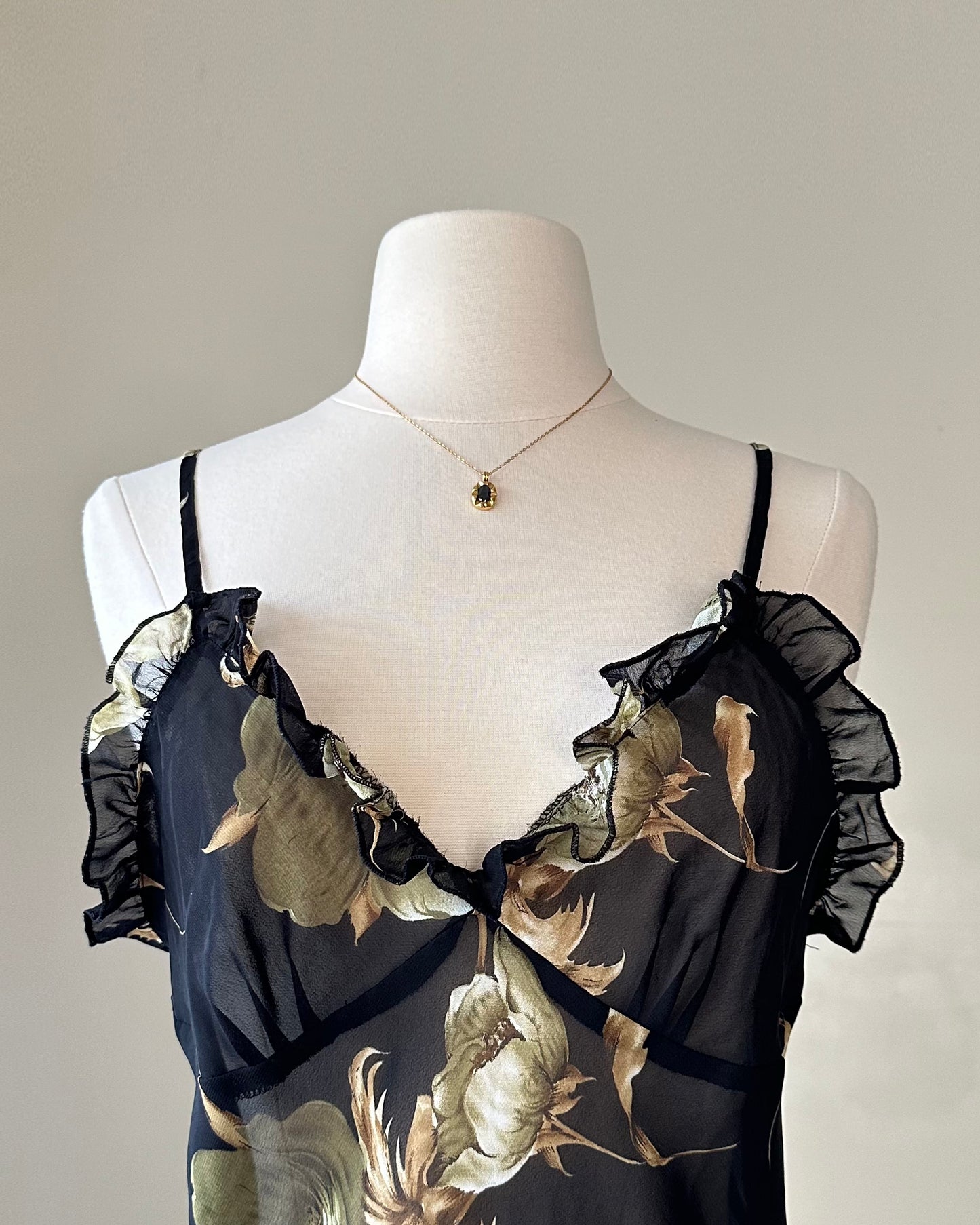 Sultry sheer black slip dress featuring golden blooming flowers print