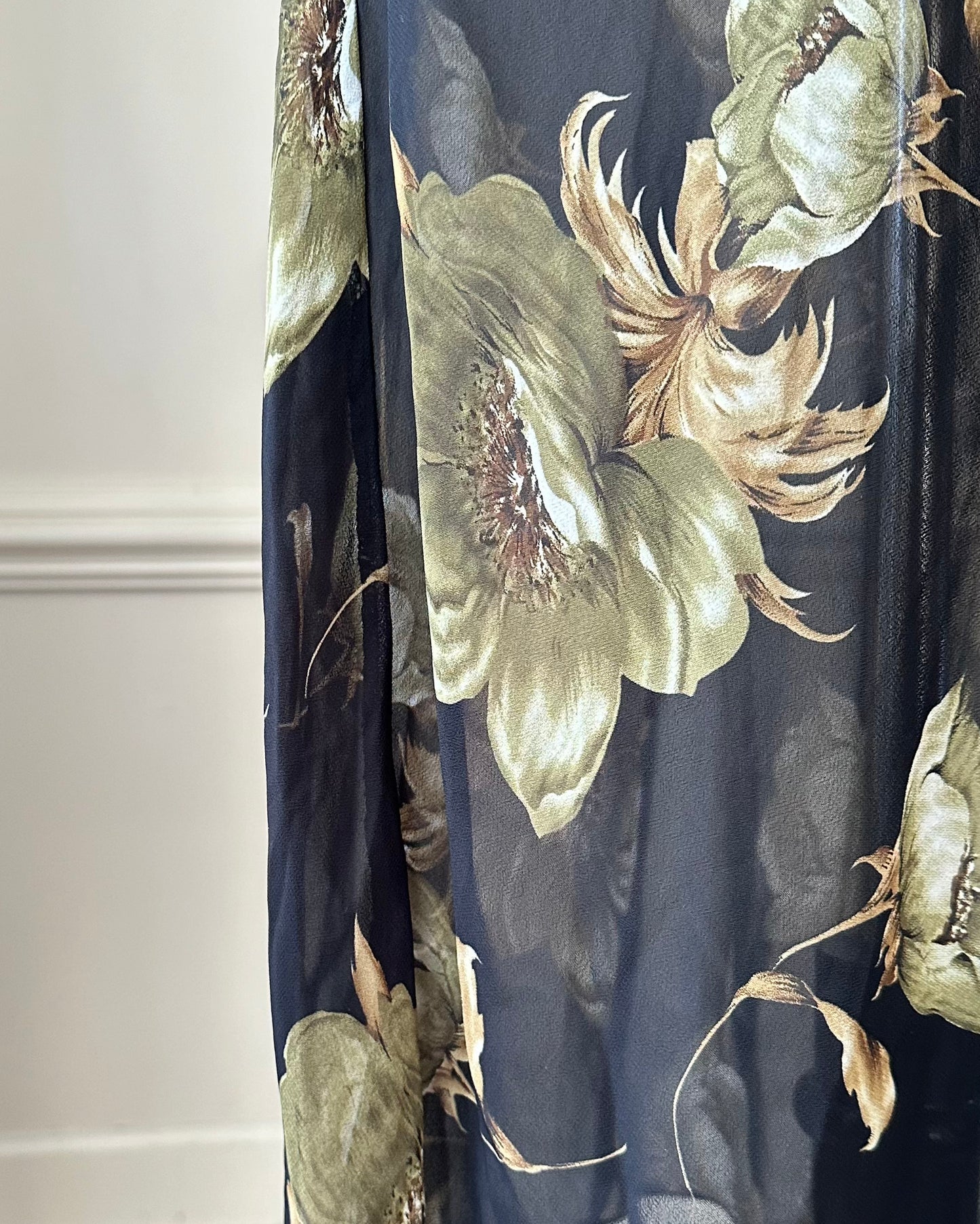 Sultry sheer black slip dress featuring golden blooming flowers print