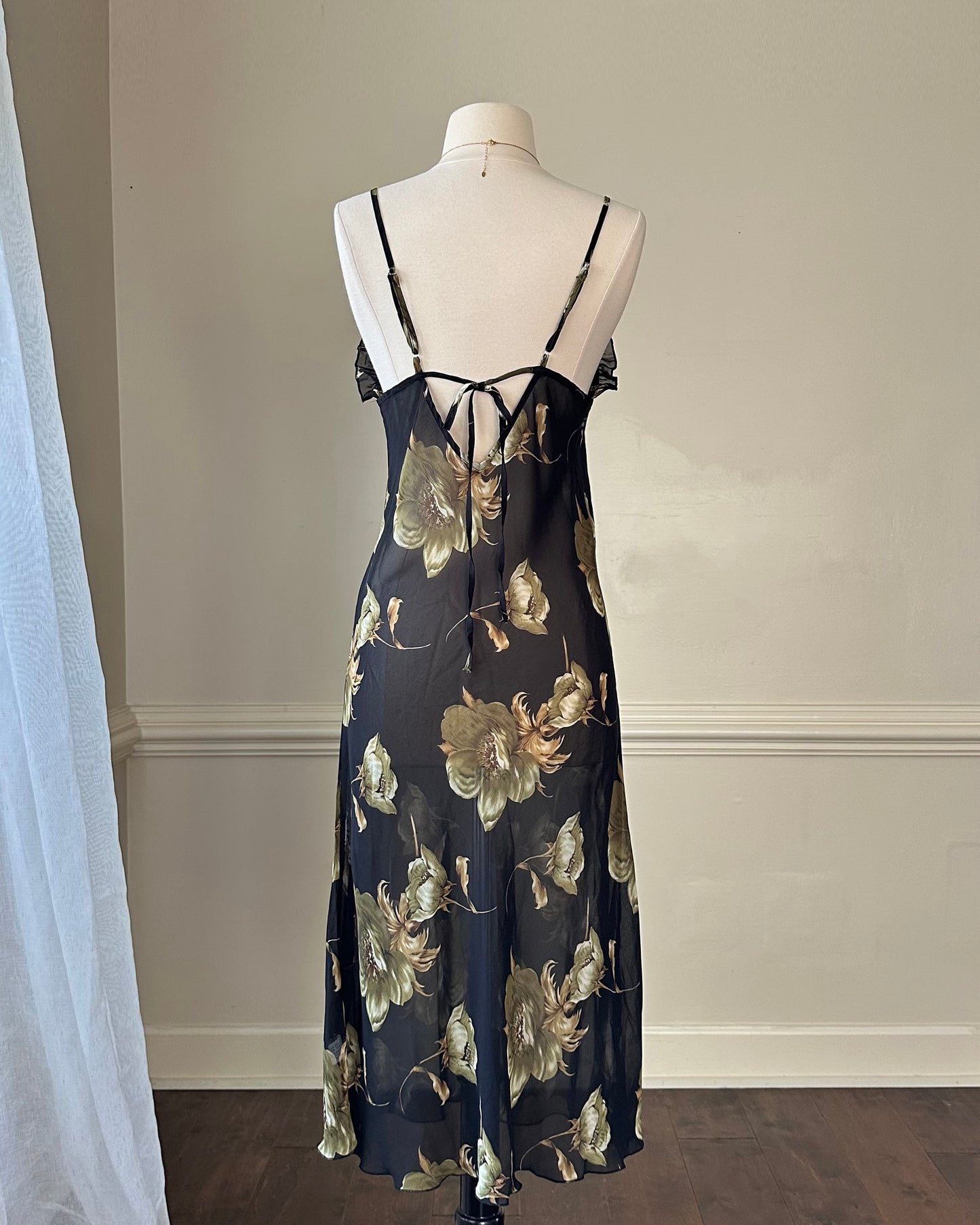 Sultry sheer black slip dress featuring golden blooming flowers print