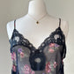 Flirty sheer black bodysuit featuring rose bouquets print with flared hips