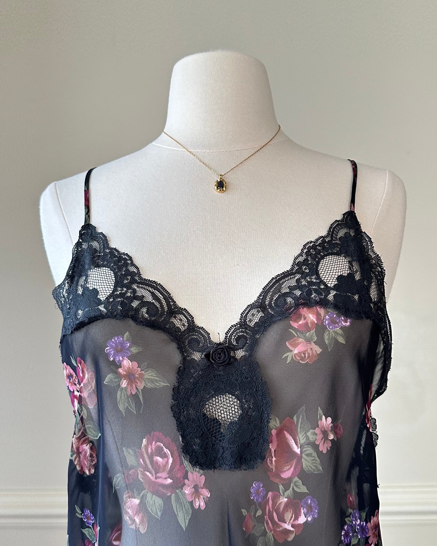 Flirty sheer black bodysuit featuring rose bouquets print with flared hips